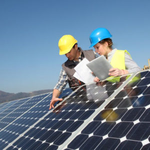 Man showing solar panels technology to female apprentice